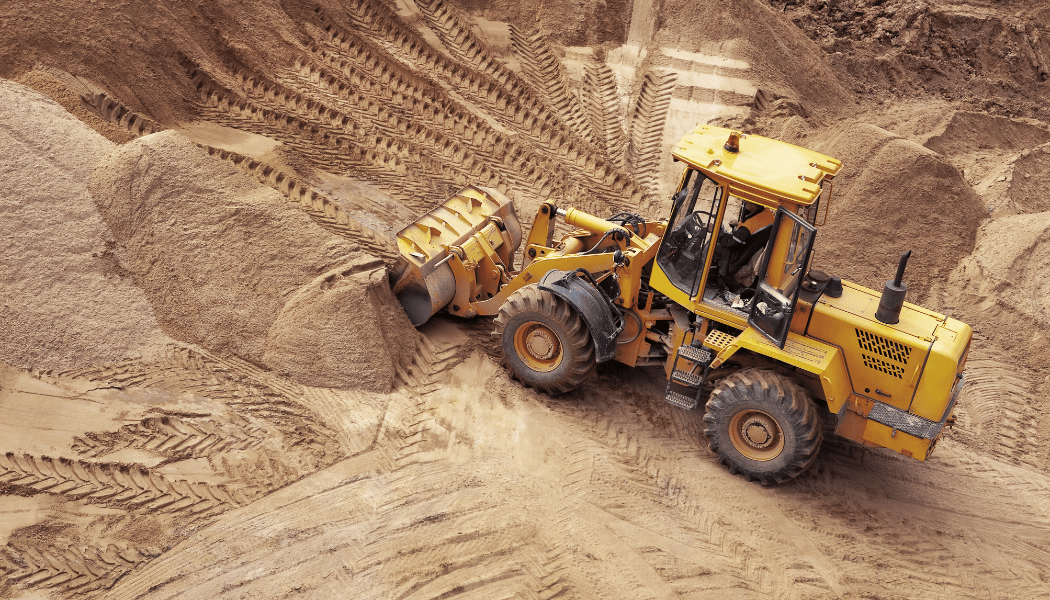 A bulldozer mowing dirt away